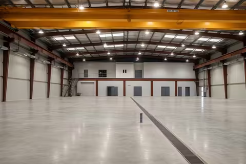 Workshop interior with the ten-tonne overhead travelling crane on red steel portal frames