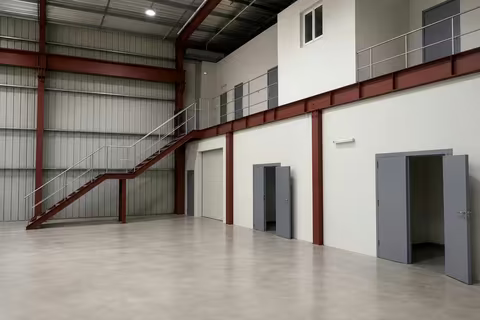 Two-storey office block, mezzanine and stores built inside the workshop