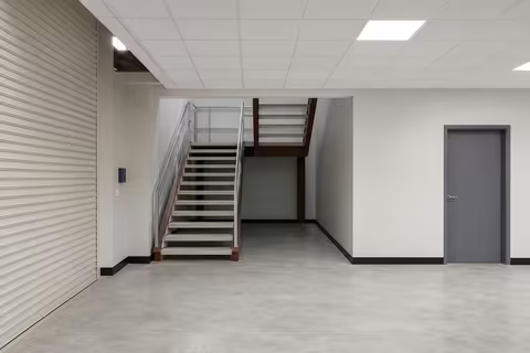 Fitted-out lobby with the steel staircase up to the mezzanine